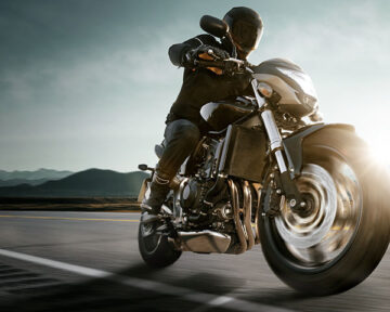 オートバイで爽快に走る男性